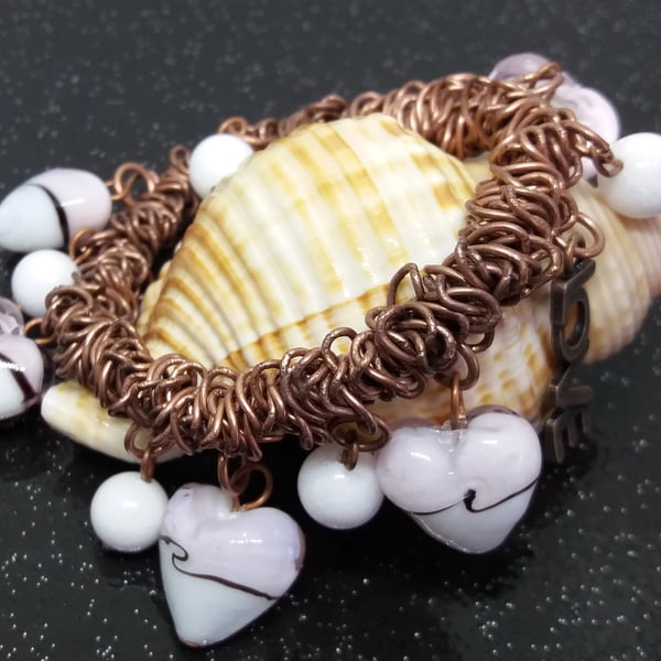 BR15Bungee style bracelet  on antique copper colour chain link with heart beads.