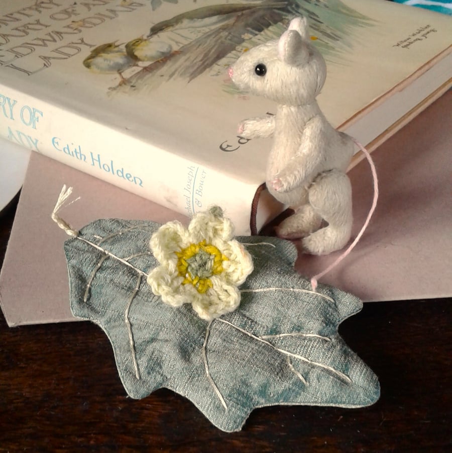 Miniature mouse 'Primrose' fully jointed, hand stitched sitting on a silk leaf.