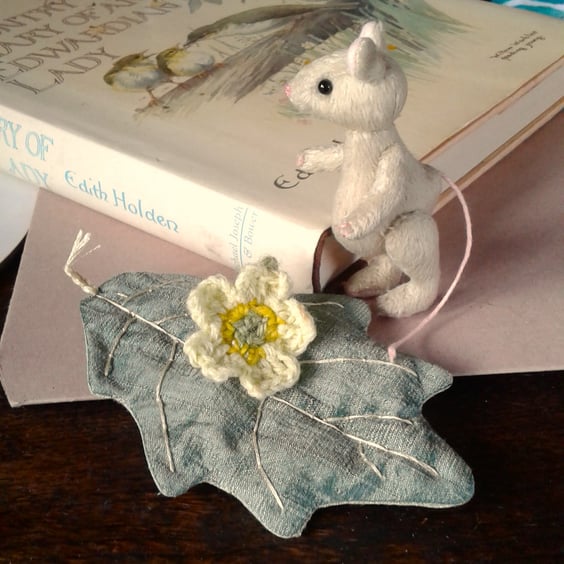Miniature mouse 'Primrose' fully jointed, hand stitched sitting on a silk leaf.