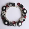 Black, white, pearlescent, red, grey, silvery button charm bracelet