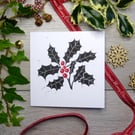 Holly and Berries Christmas card in black and red, handprinted from a linocut