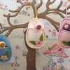 Hanging wool felt Easter egg with a tiny Waldorf doll