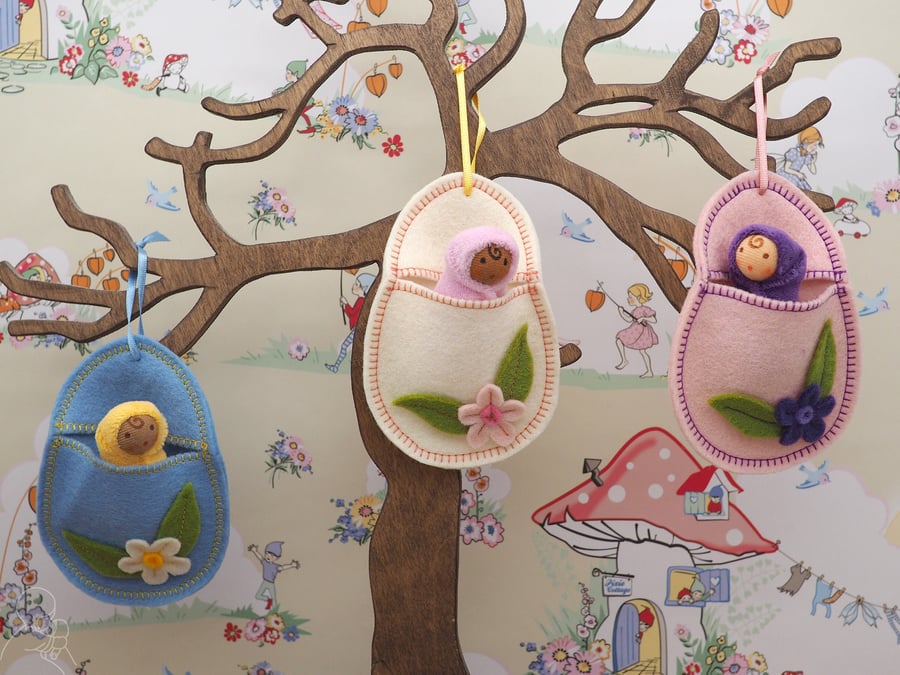 Hanging wool felt Easter egg with a tiny Waldorf doll