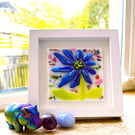 Framed, colourful fused glass abstract flower 
