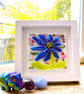 Framed, colourful fused glass abstract flower 