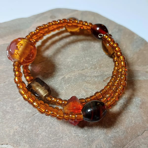 Memory wire bracelet in shades of amber, beaded wrap cuff