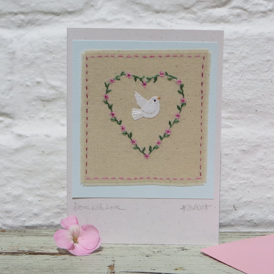 Delicately hand embroidered heart of roses and leaves with dove applique