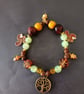 Elasticated beaded red squirrel, tree of life and gold acorn charm bracelet  - Image 2