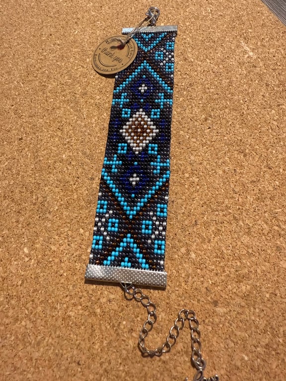 Beautiful handmade beaded bracelet features a striking geometric pattern