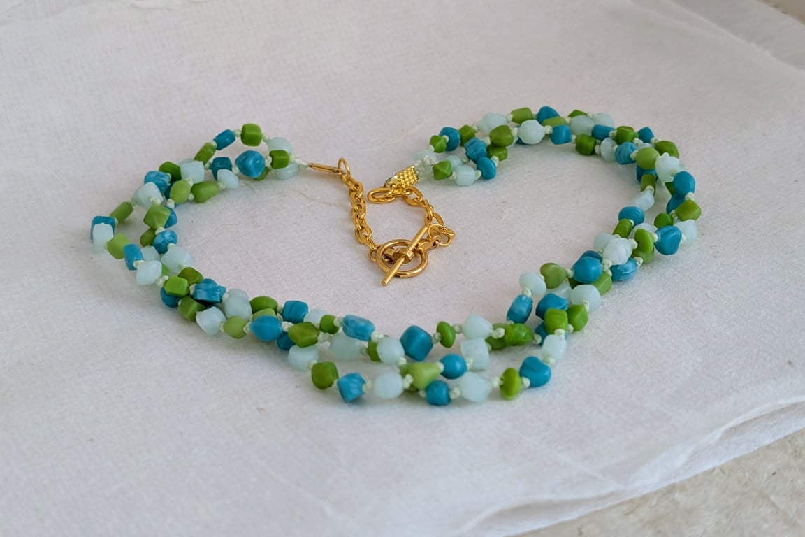 Teal, lime and blue glass bead knotted necklace with gold chain and toggle clasp