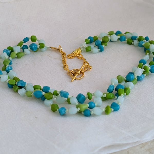Teal, lime and blue glass bead knotted necklace with gold chain and toggle clasp