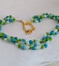 Teal, lime and blue glass bead knotted necklace with gold chain and toggle clasp