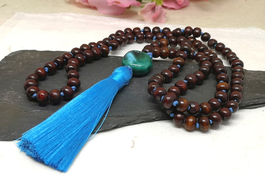 Wooden mala bead necklace with ceramic focal and blue tassel