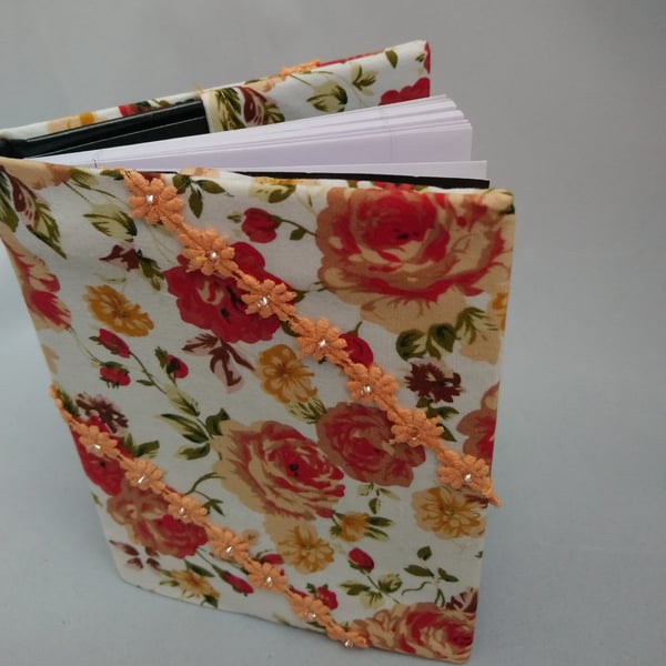 Note Book covered in fabric with lace flowers with beads