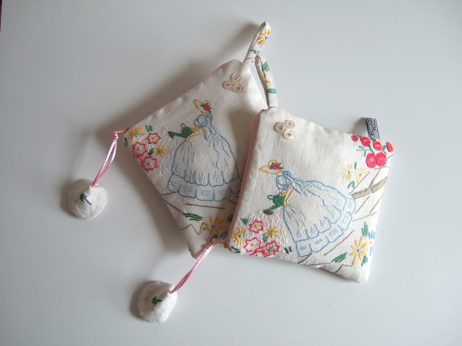 Cosmetics or storage bag with upcycled vintage embroidered crinoline lady