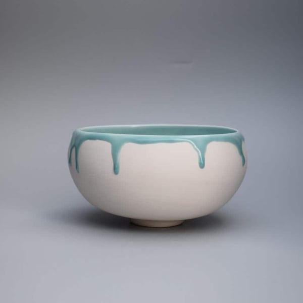 Decorative porcelain bowl with green celadon glaze