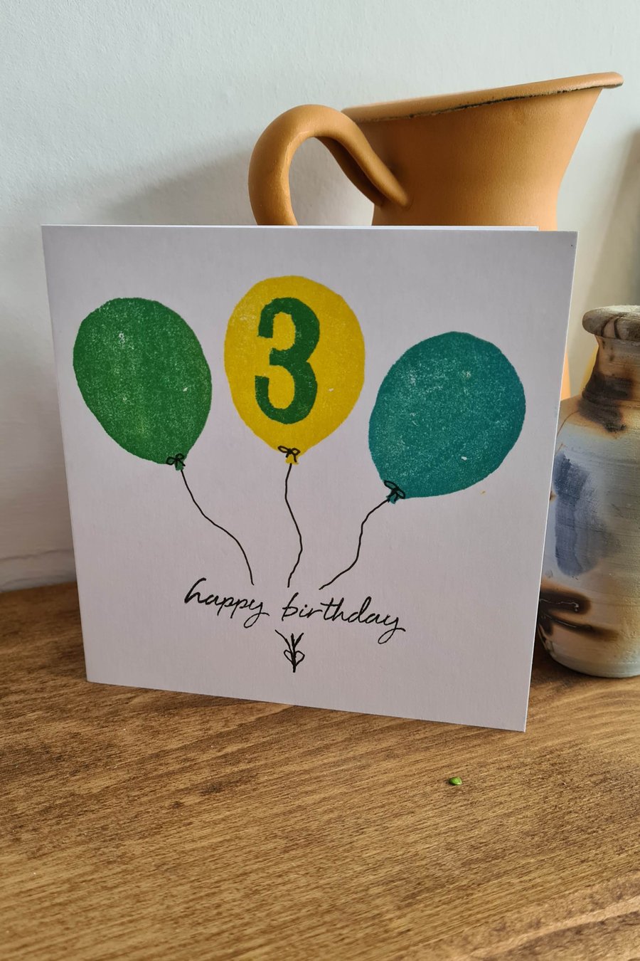 Numbered balloon birthday card handprinted yellow green blue