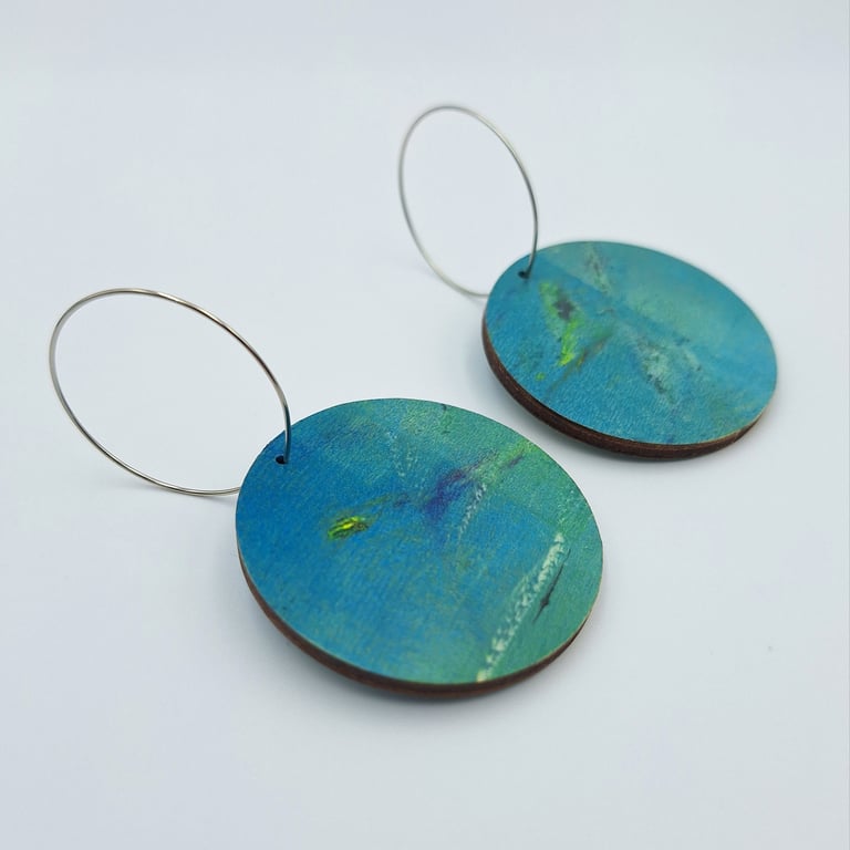 Blue wooden disc earrings printed with flashes of white and yellow