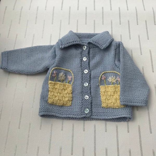 Baby's cardigan with flower basket feature