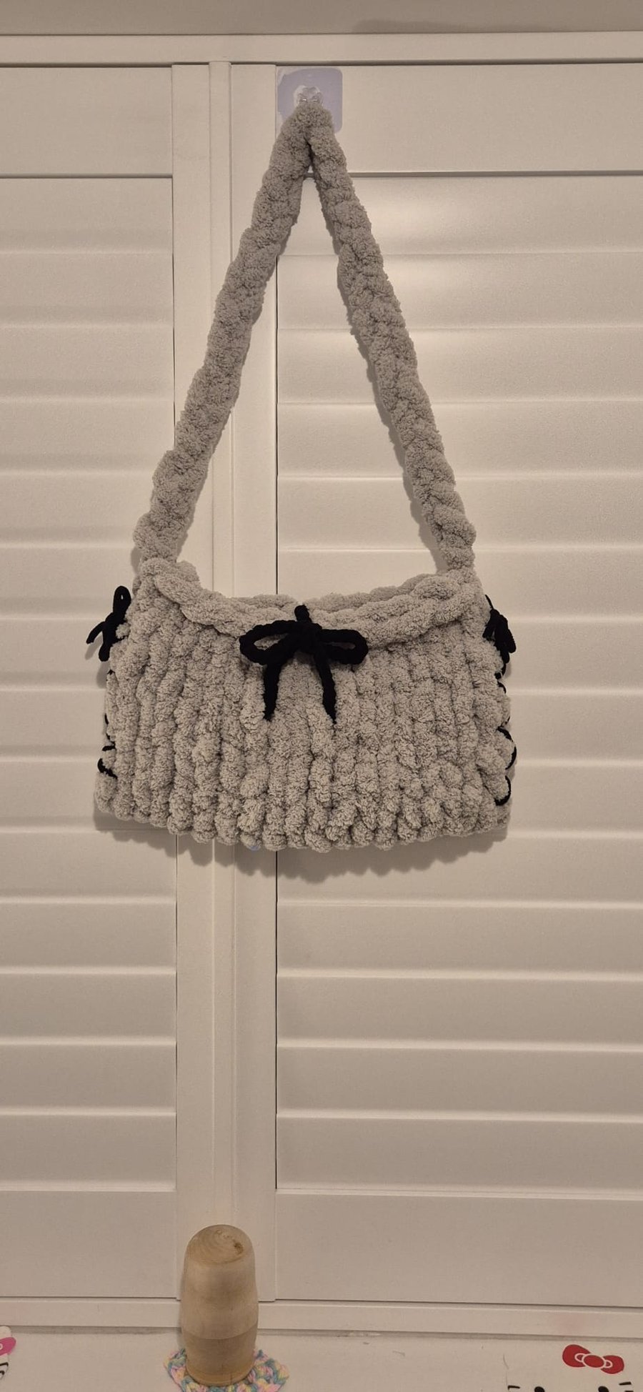 Beautiful hand knitted handbag with bow details in grey