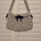 Beautiful hand knitted handbag with bow details in grey