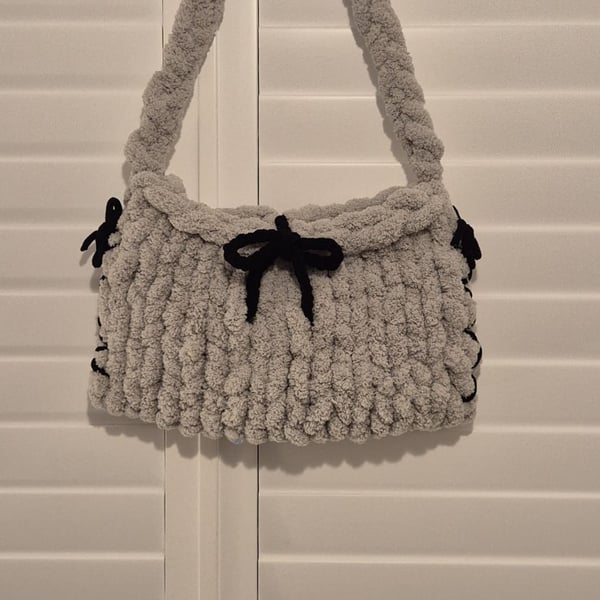 Beautiful hand knitted handbag with bow details in grey