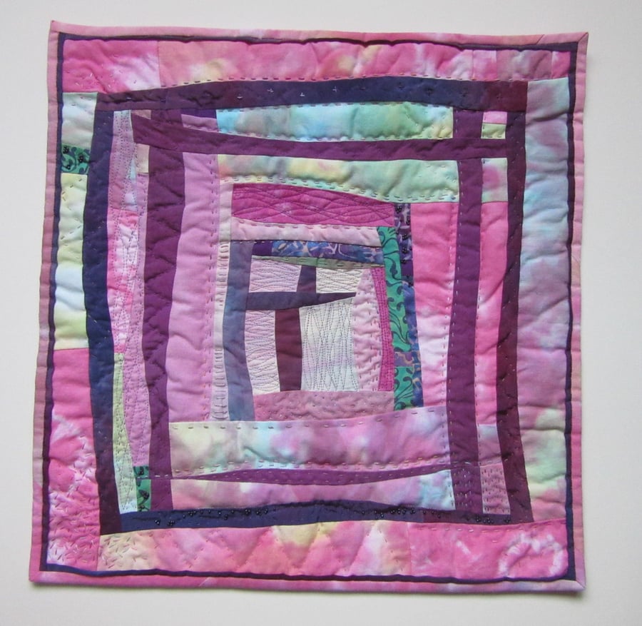 ART QUILT WALL HANGING.  ABSTRACT FABRIC PICTURE IN PINK AND MAUVE