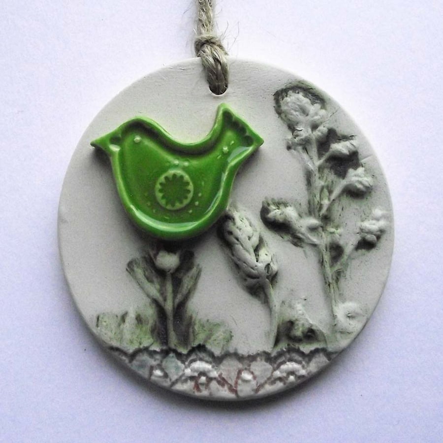 Pottery decoration with natural flower and green bird decoration.