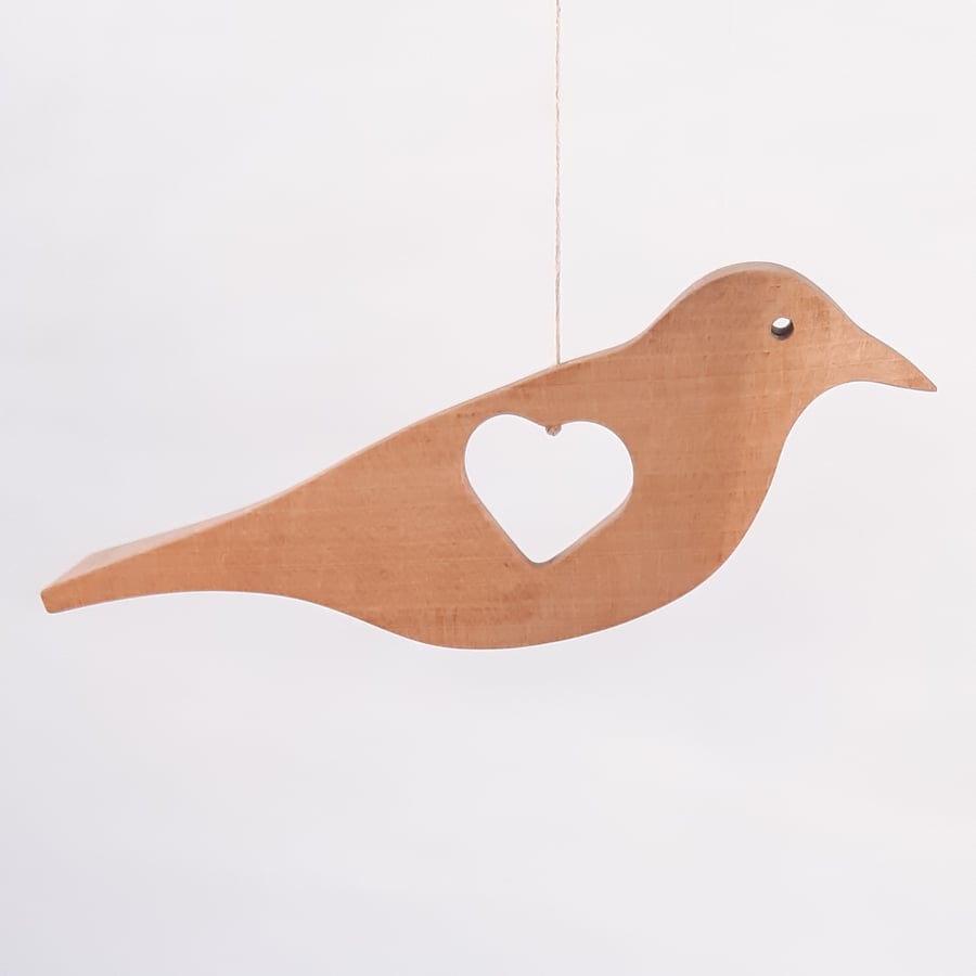 Hanging bird with heart cut-out