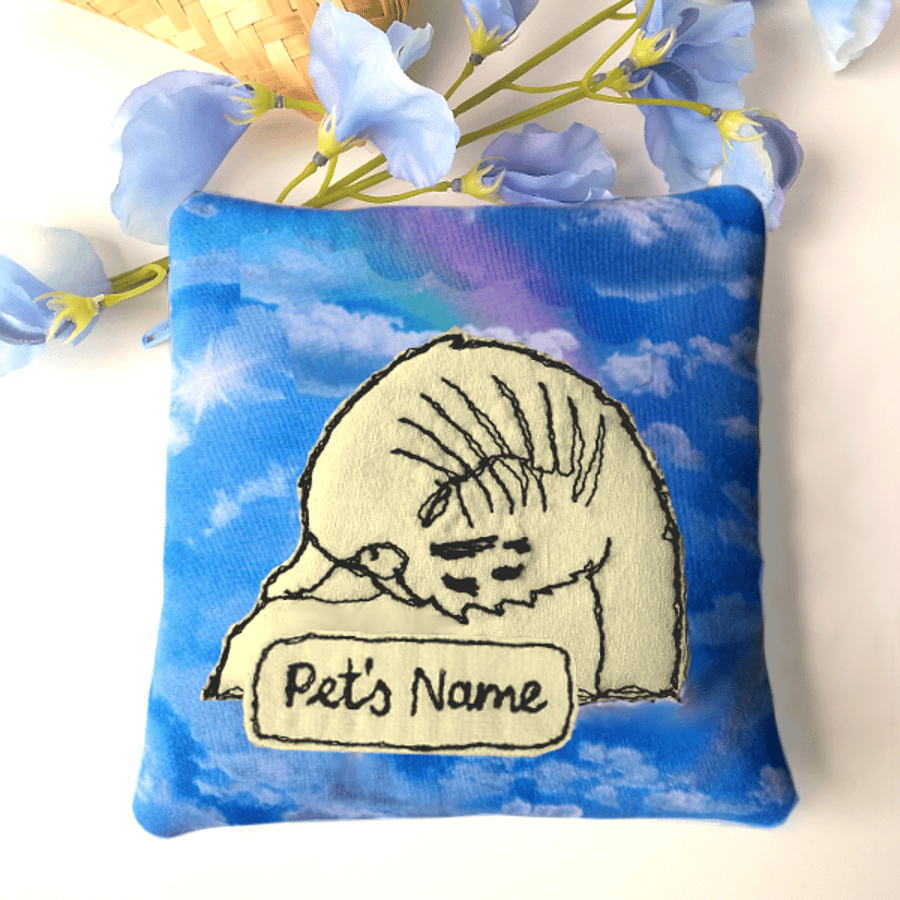 Pet memorial pouch – Yellow sleeping bird image against blue sky with rainbows