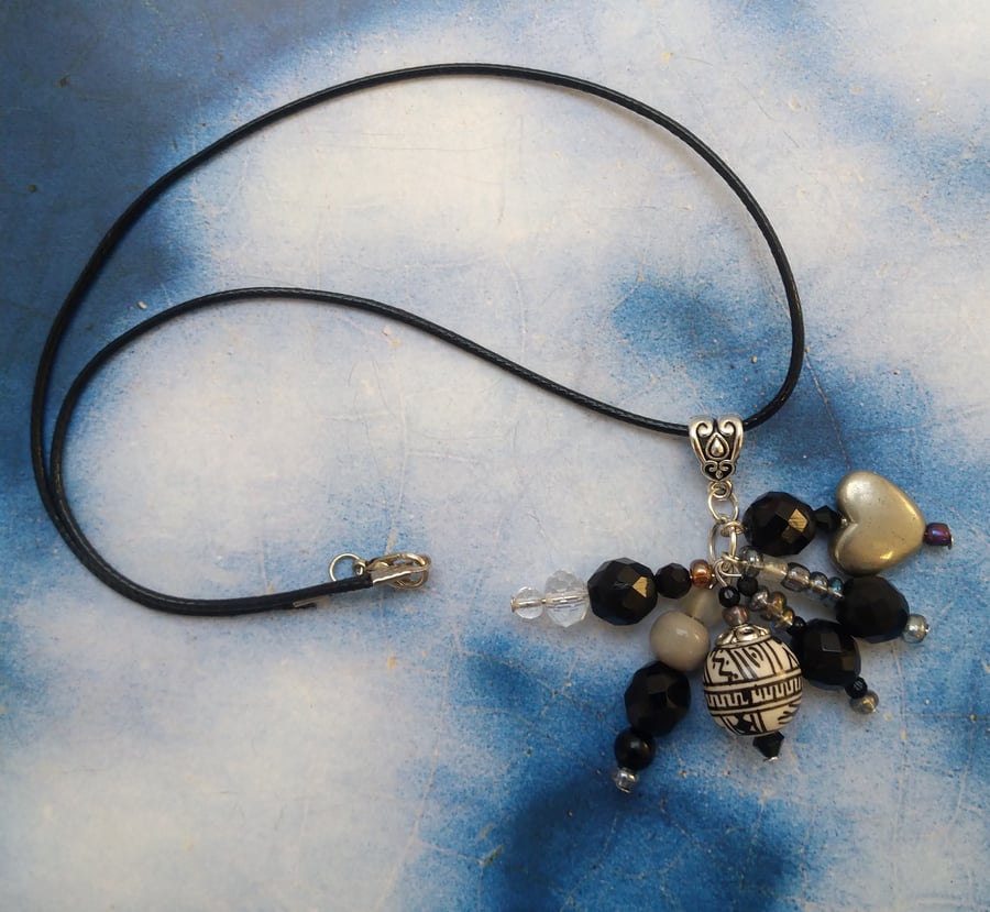 A Pendant Cluster of Black White and Silver  Beads