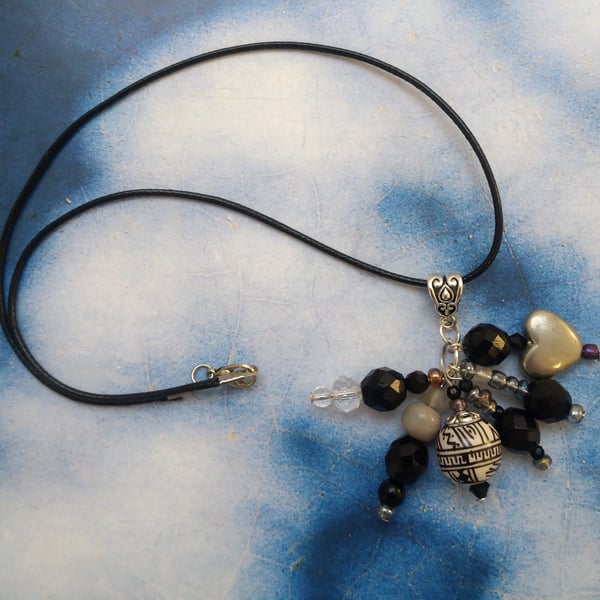  A Pendant Cluster of Black White and Silver  Beads