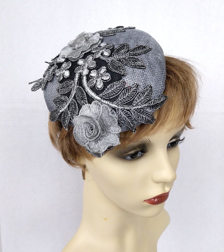 Silver grey pillbox shaped fascinator embellished with applique