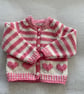 Baby’s pink and cream striped cardigan with heart motifs - Image 1
