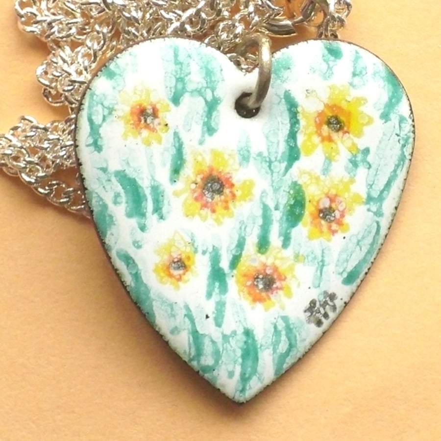 sunflowers painted on a heart pendant