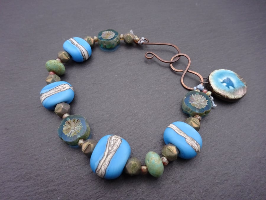 blue lampwork glass beaded bracelet, ceramic bird charm