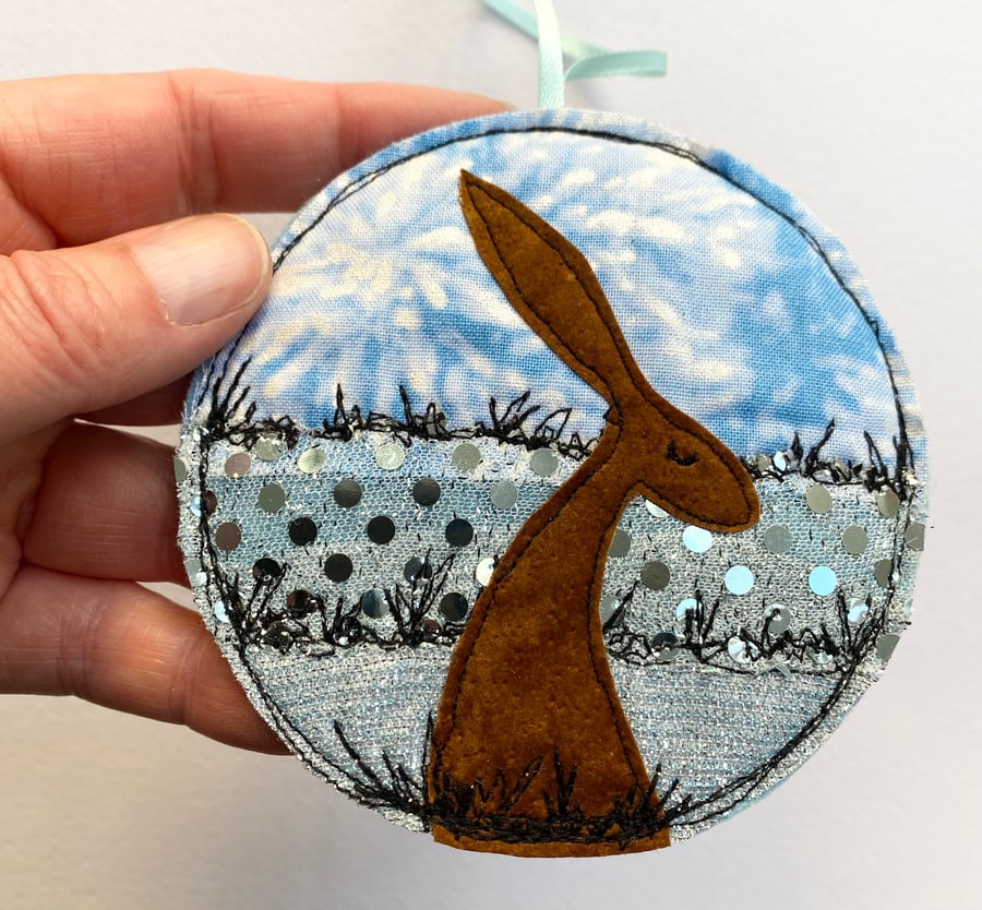 Upcycled embroidered winter hare home decoration. 