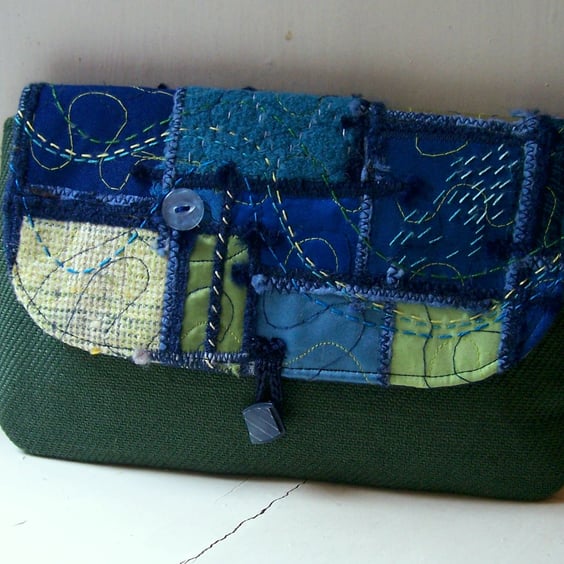 Clutch bag with unique created-textile panel 