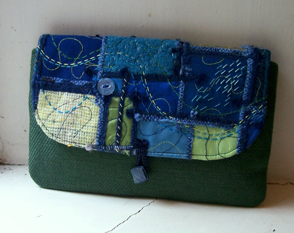 Clutch bag with unique created-textile panel 