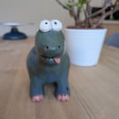 Ceramic diplodocus with its tongue out
