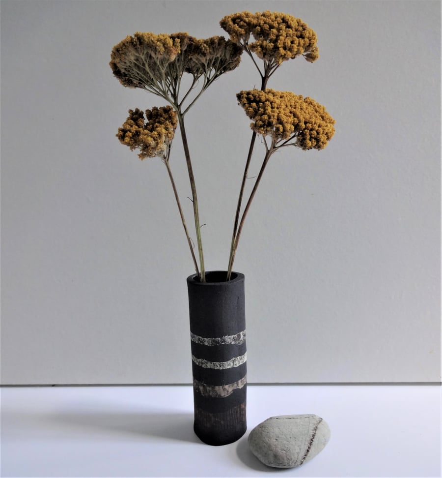 Helen.  Black ceramic vase with bands of colour.