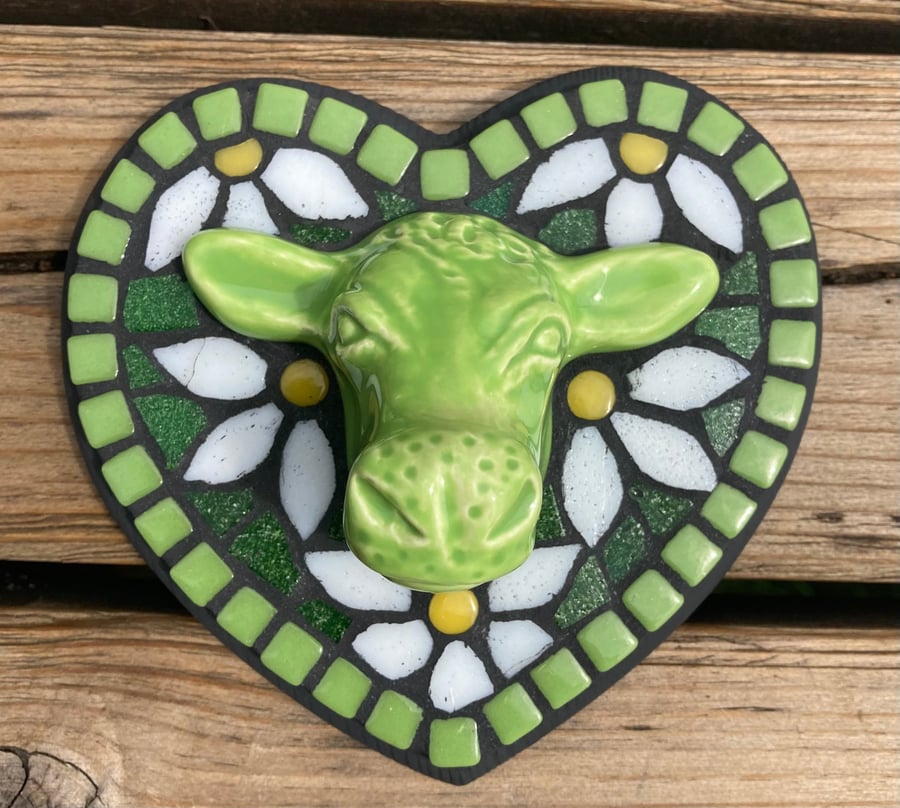 Mosaic wall hanging with lime green ceramic cow head and mosaic daisies.