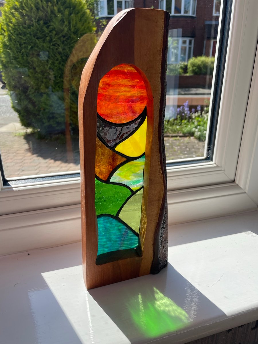 ‘Sunset over the English countryside’ stained glass framed in elder wood.