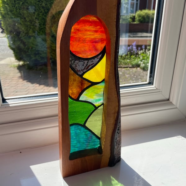 ‘Sunset over the English countryside’ stained glass framed in elder wood.