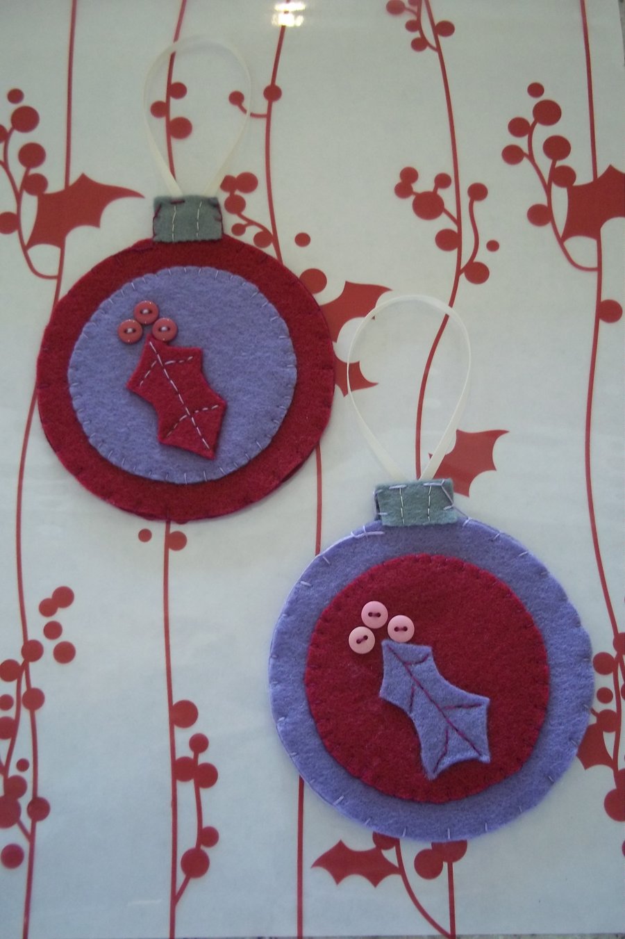 Pair of bauble shaped felt handstitched Christmas decorations purple holly. 