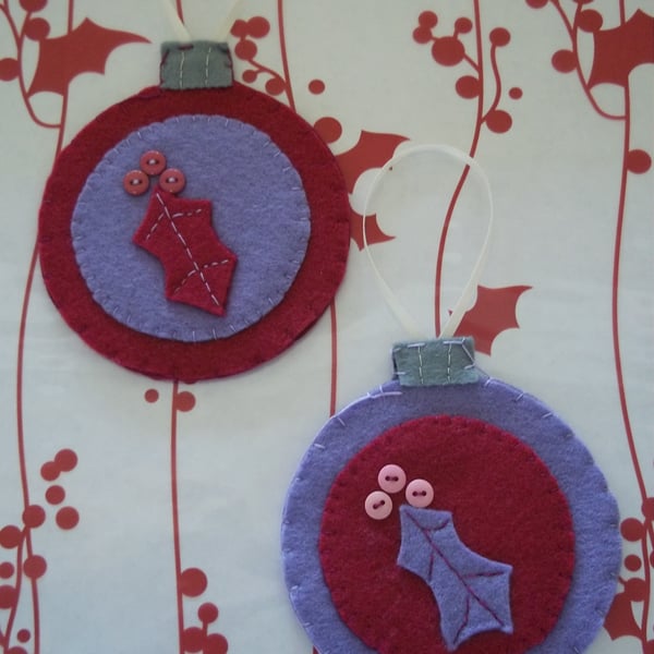 Pair of bauble shaped felt handstitched Christmas decorations purple holly. 