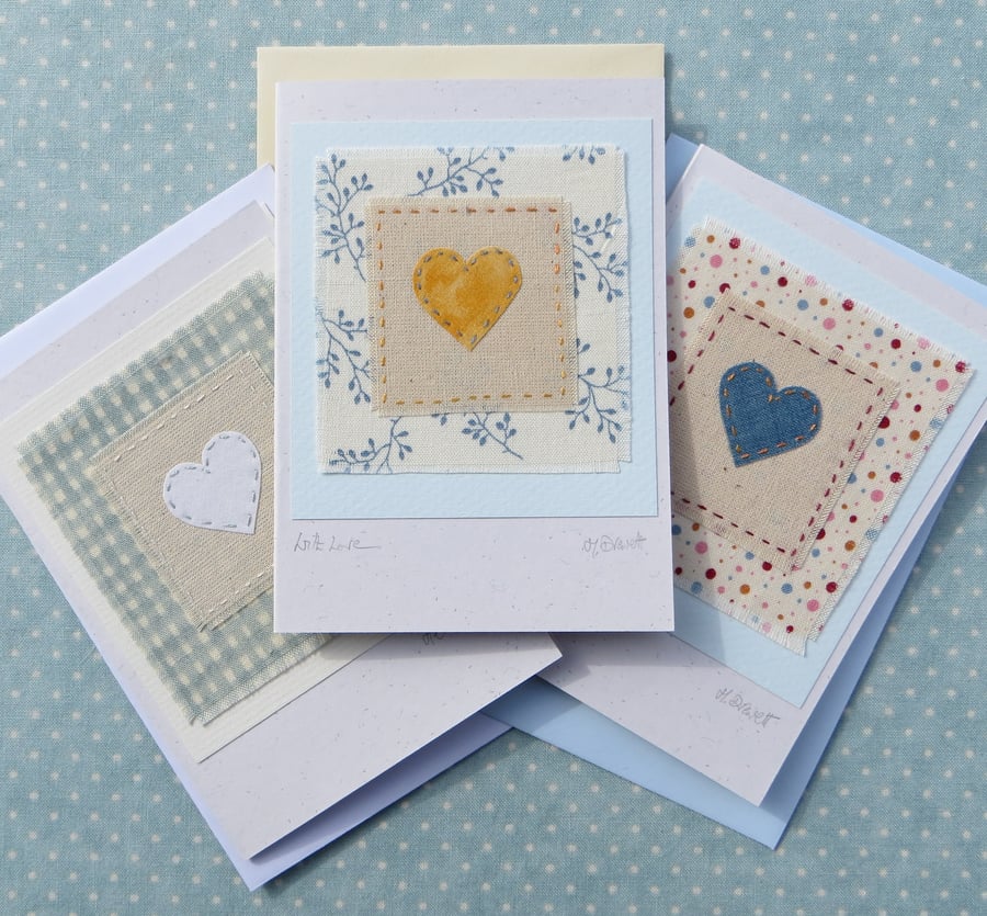 Three hand-stitched heart cards