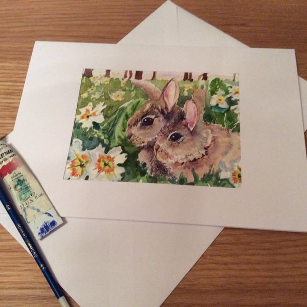 Easter card of an Original watercolour painting of Two rabbits with primroses.