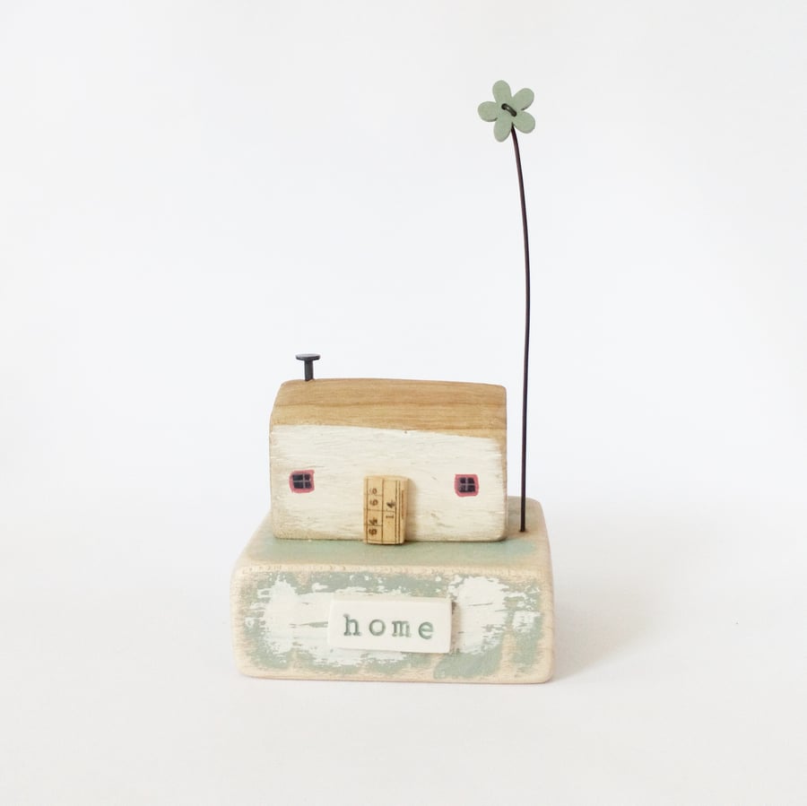 Little wooden house with flower 'home'