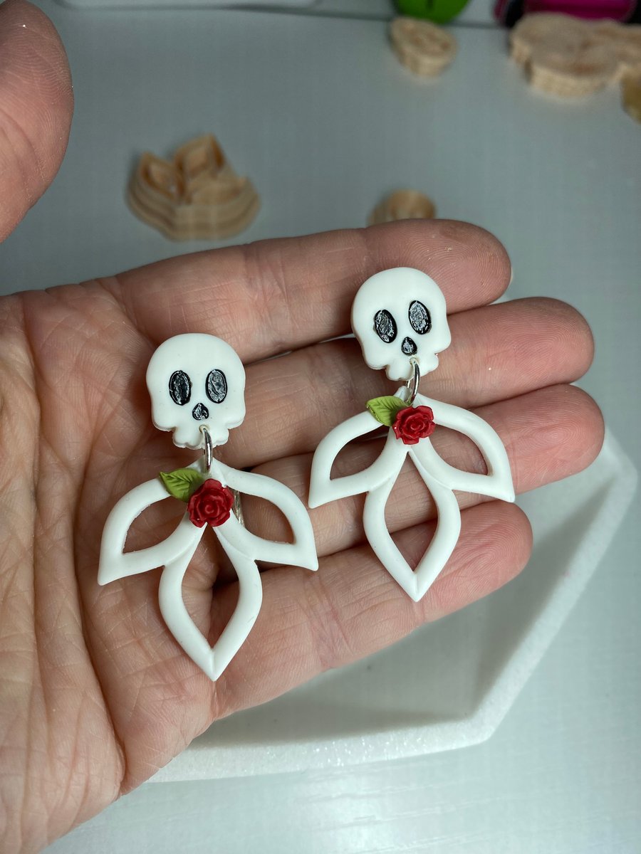 Halloween inspired Fimo polymer clay skull ghost earrings, with a red rose